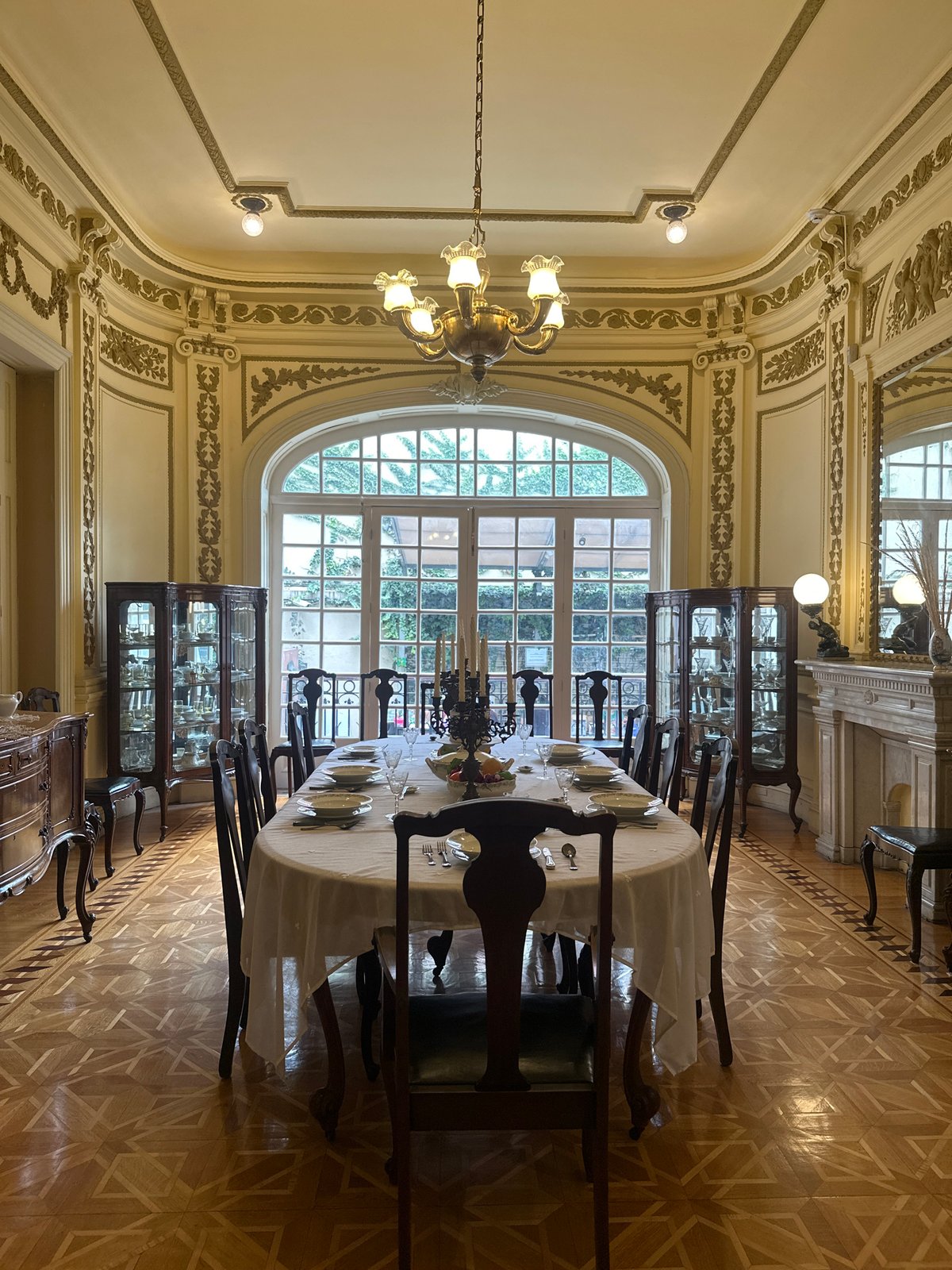 Ornate Mexico City dining room with antique clock and stained glass