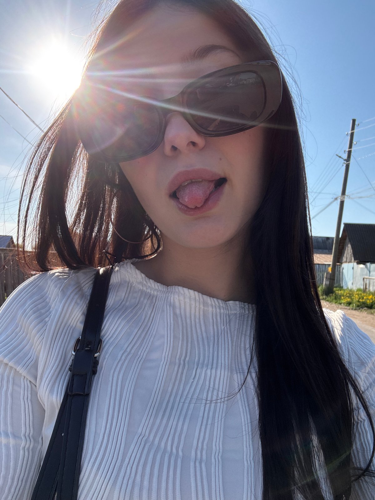 Woman poses playfully in striped shirt in Foki, Russia