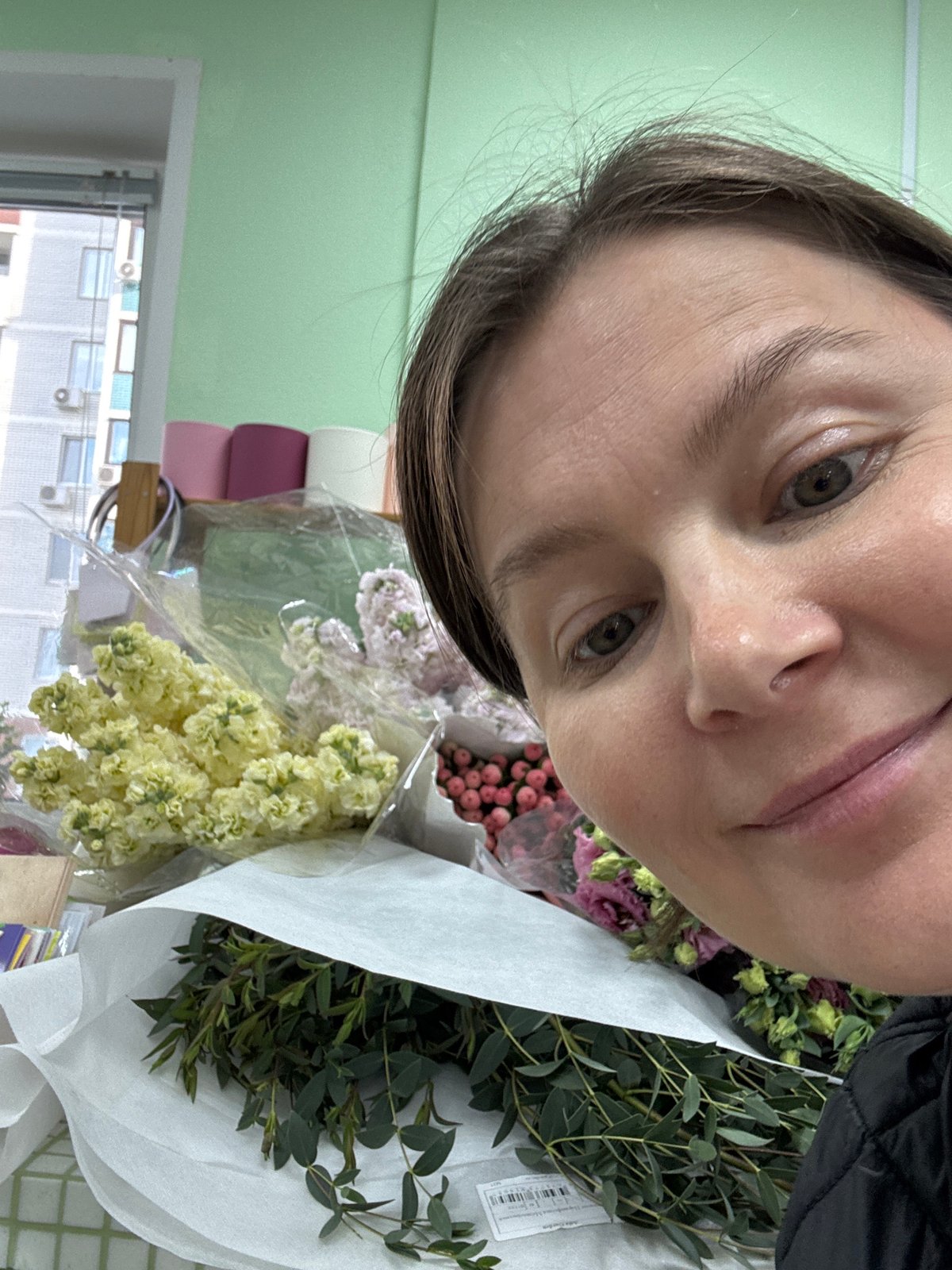 Florist documents flower arranging session in Izhevsk shop