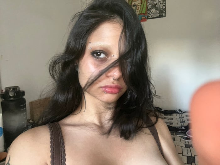 Woman with facial piercings photographed in Buenos Aires apartment