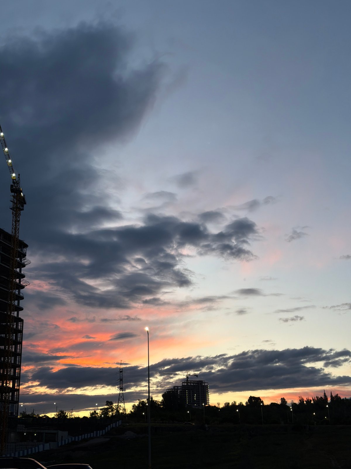 Construction continues at dusk in Yerevan high-rise project