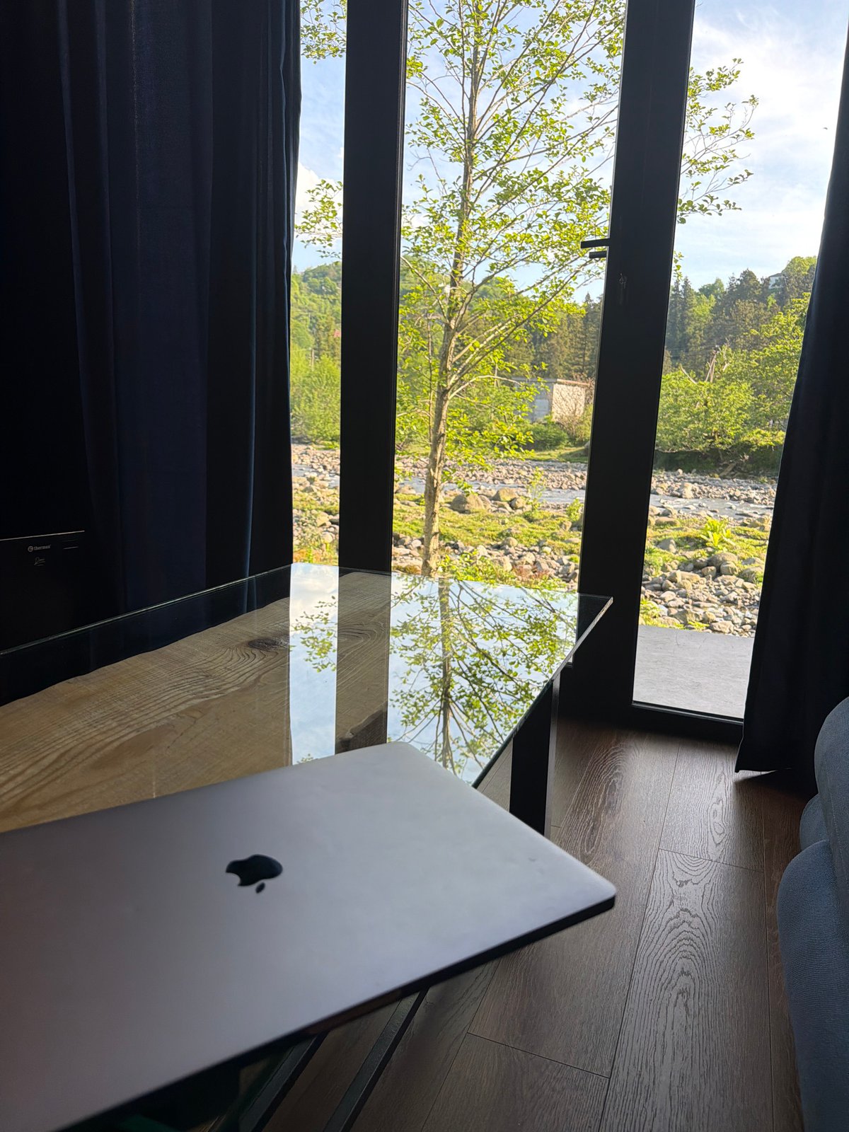 MacBook setup overlooking river landscape in Kapreshumi, Georgia