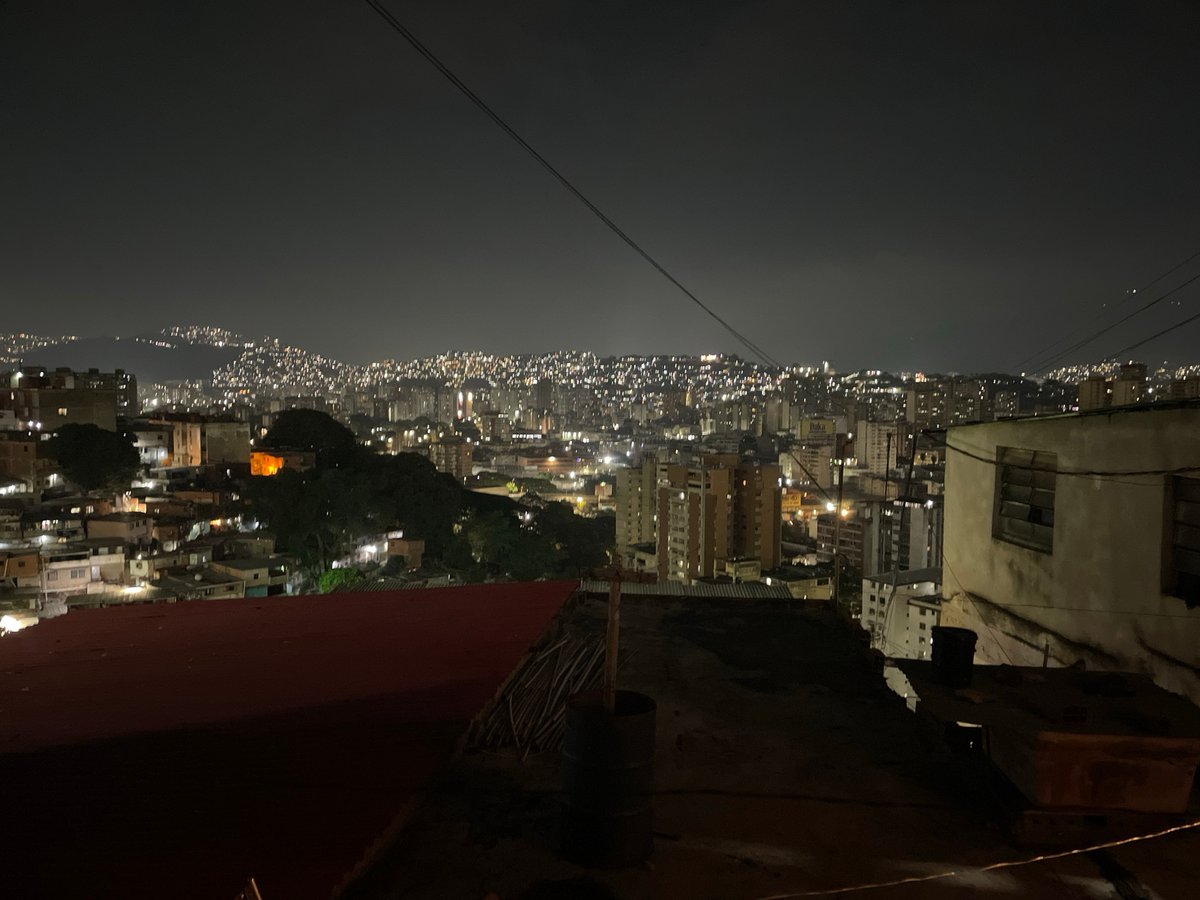 Nighttime rooftop view captured over Caracas residential area