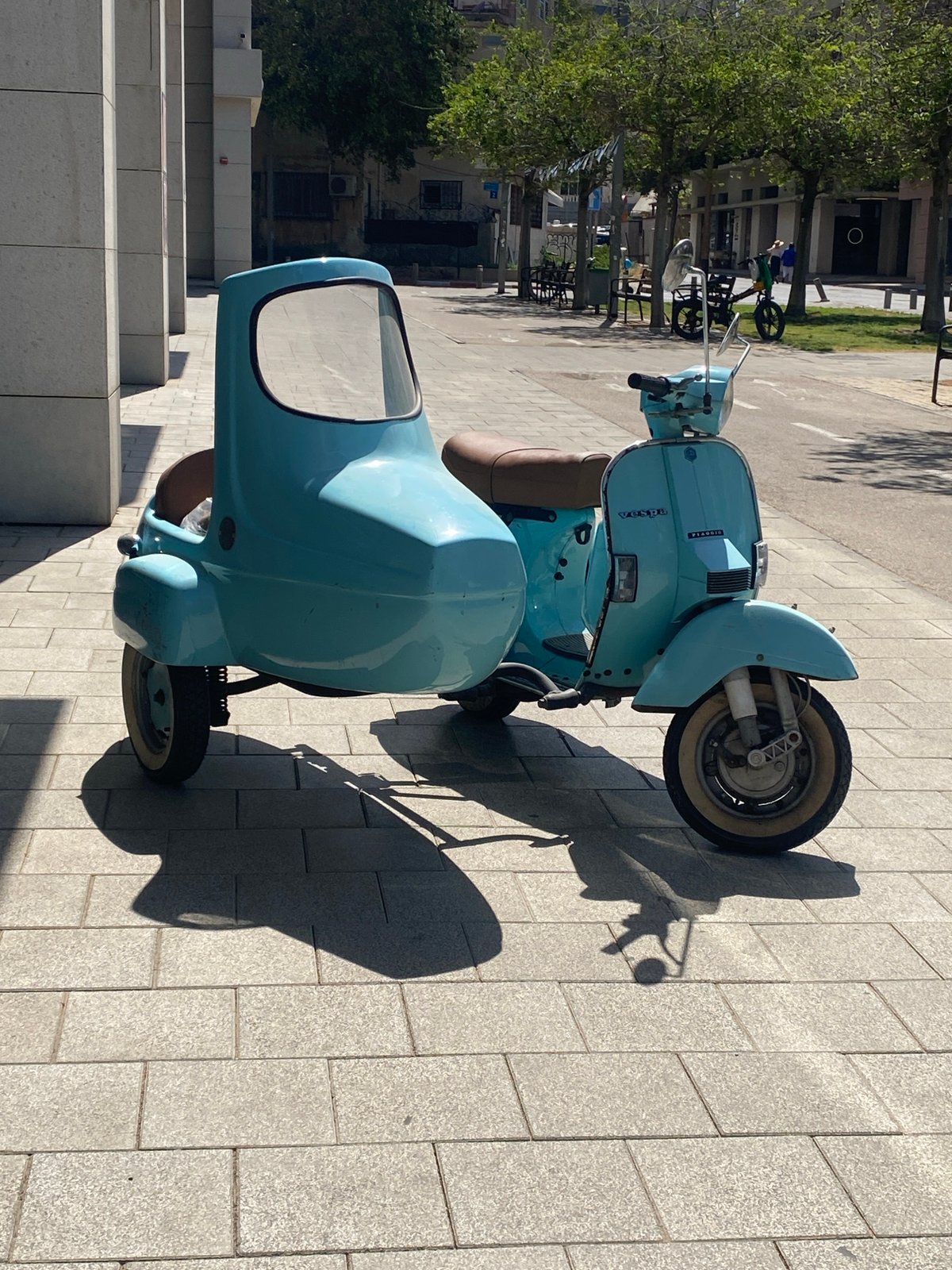 Vintage blue Vespa with sidecar spotted on Tel Aviv sidewalk