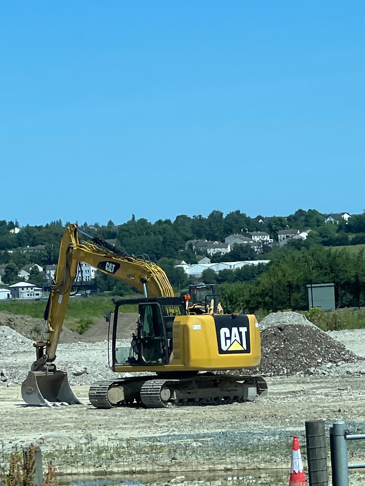 Caterpillar excavator on a clear-sky construction site in Letterkenny