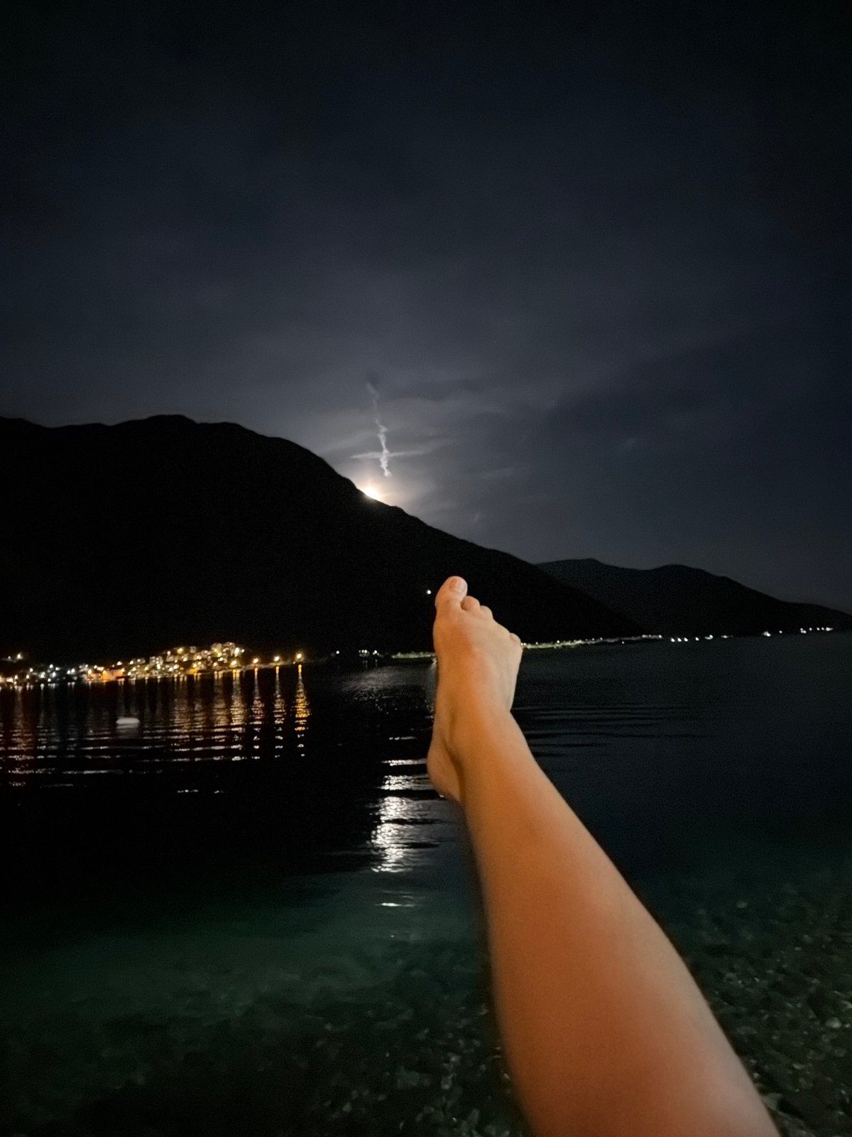 Night photography captures Risan city lights reflecting on water