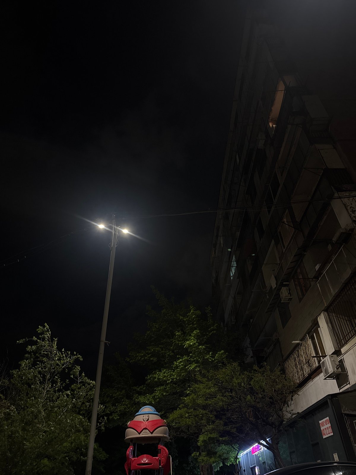 Nighttime urban scene captured in Yerevan with building and ride