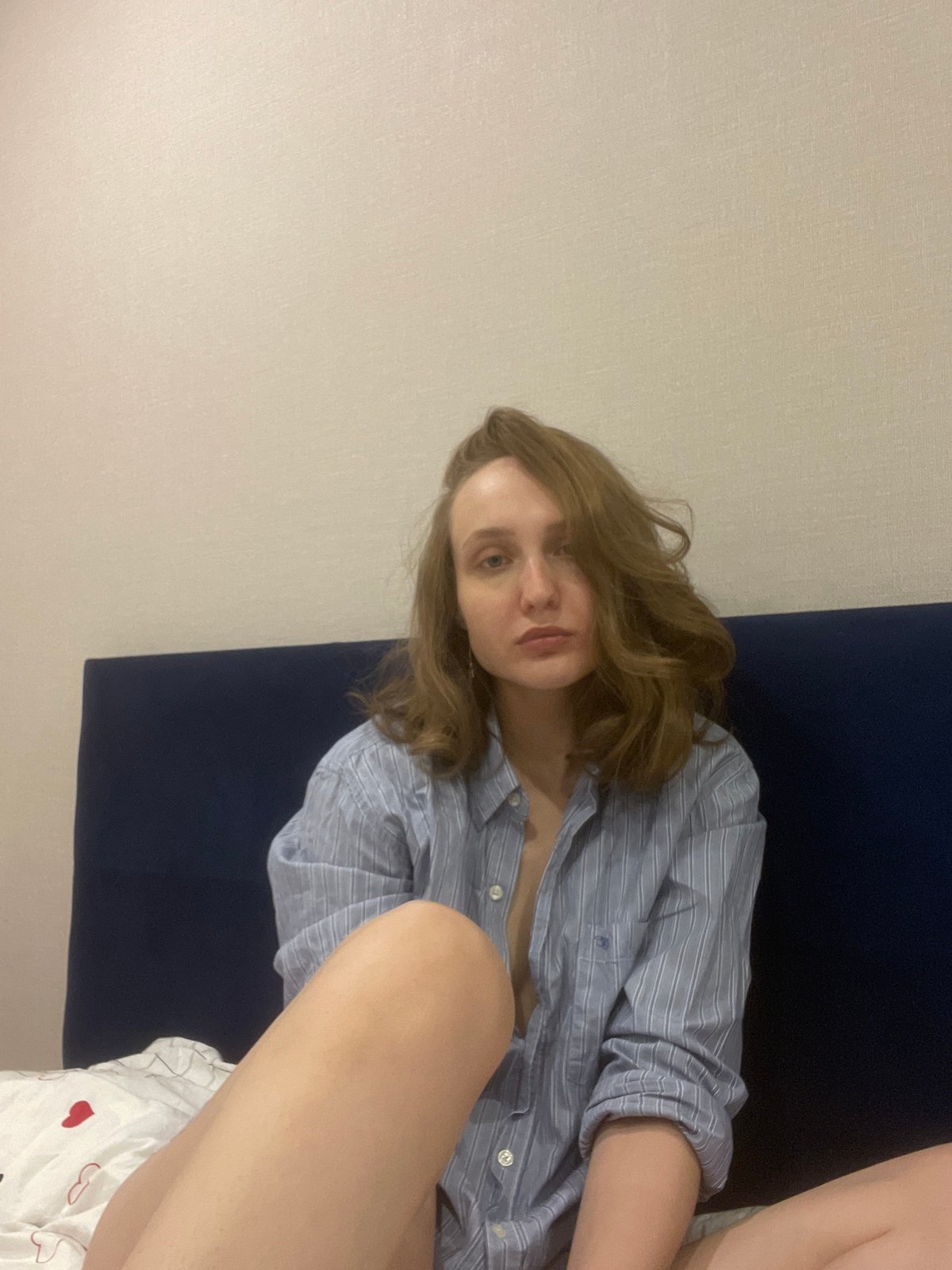 Woman takes selfies during casual indoor photo session in Podshivalovo