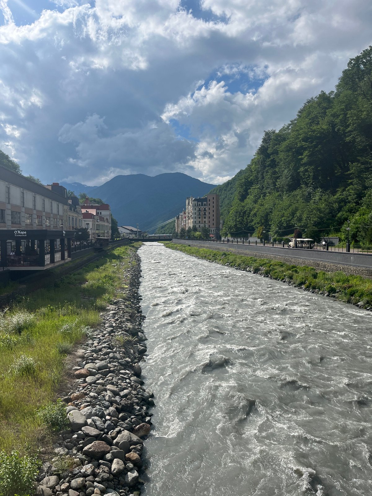 Afternoon on the bridge in Estosadok, glacial river rushing below