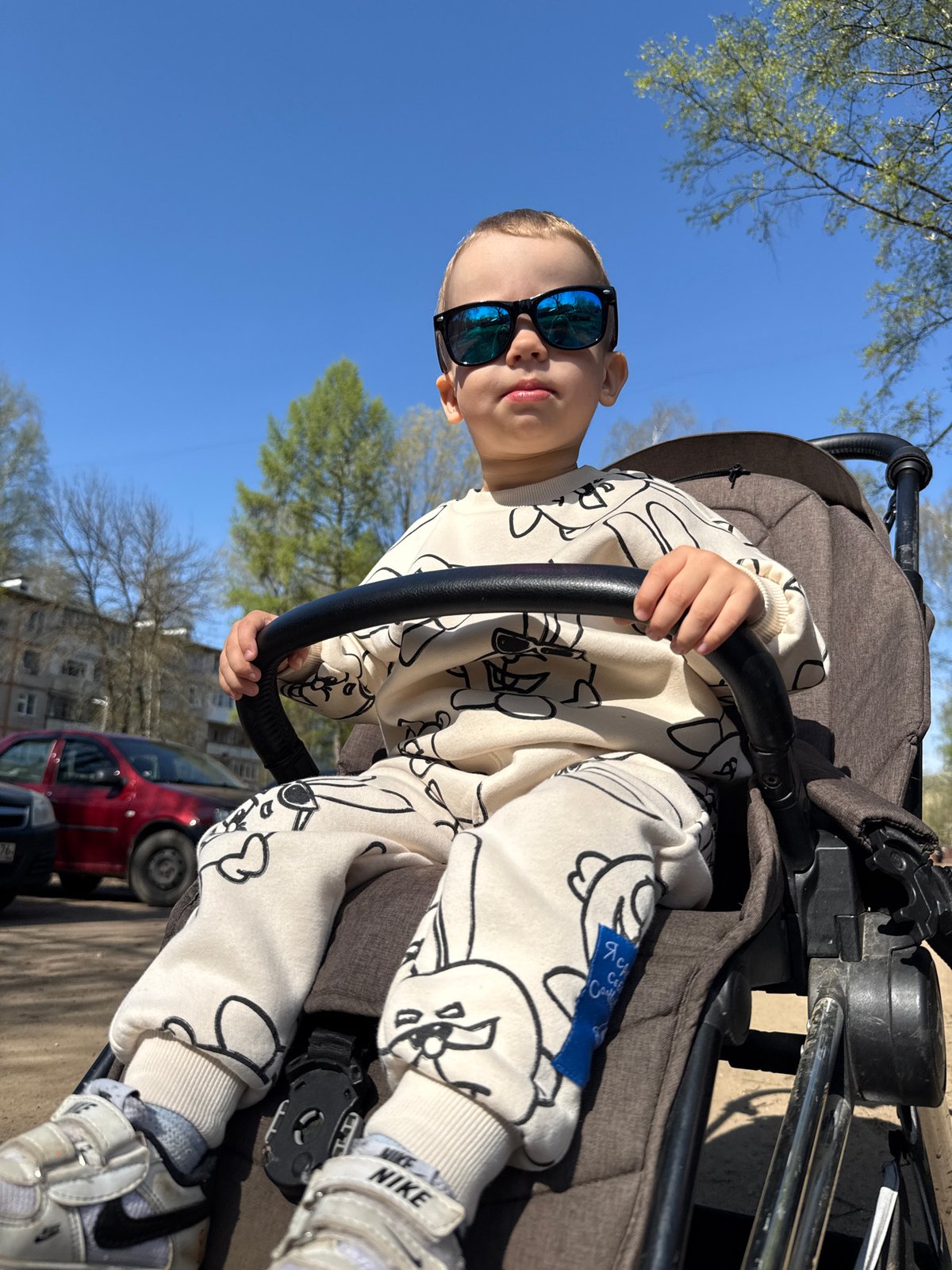 Mother and child enjoy morning stroller outing in Rusanovo