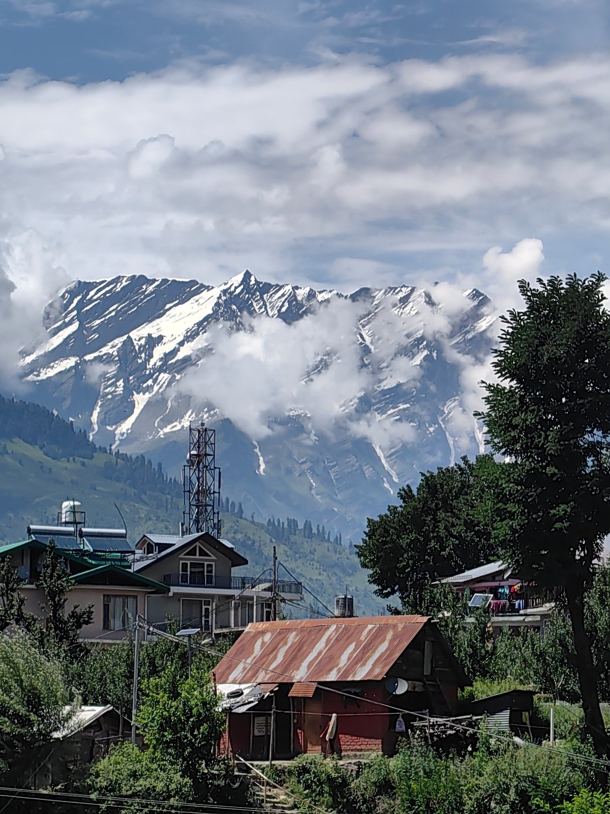 Snow-capped Himalayas loom over Aleo village buildings