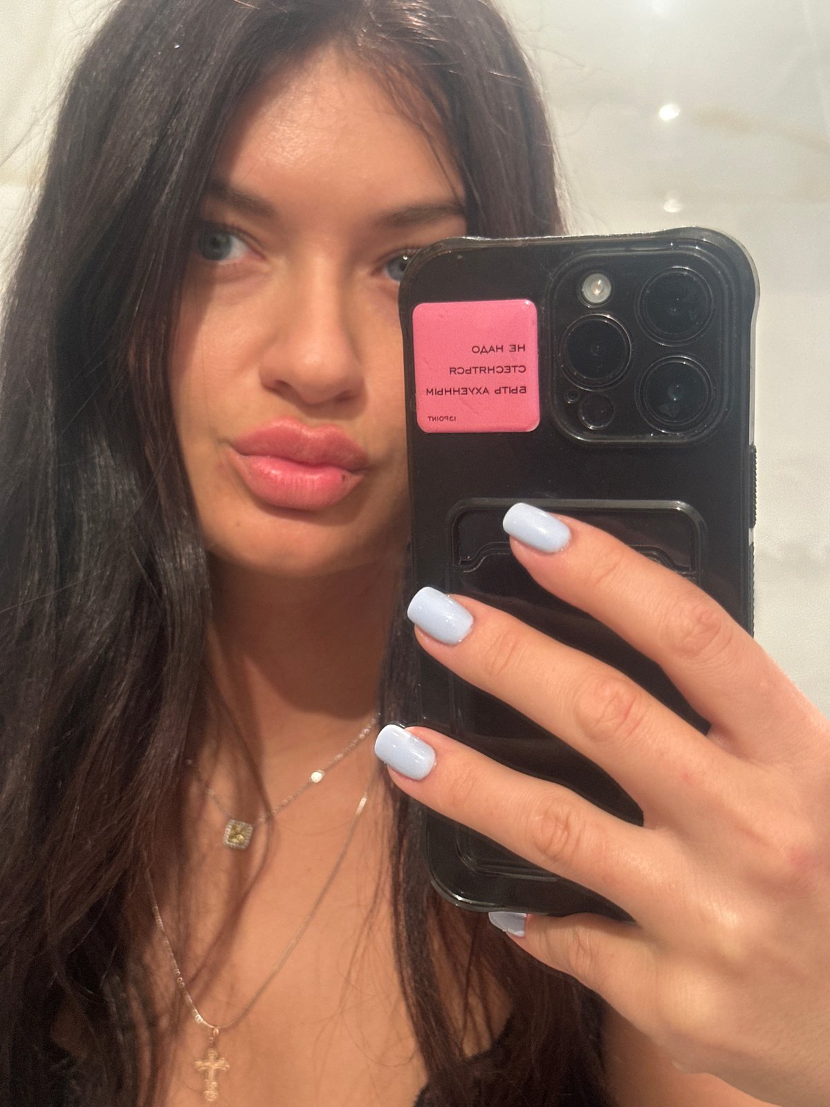 Woman takes mirror selfie indoors in Moscow