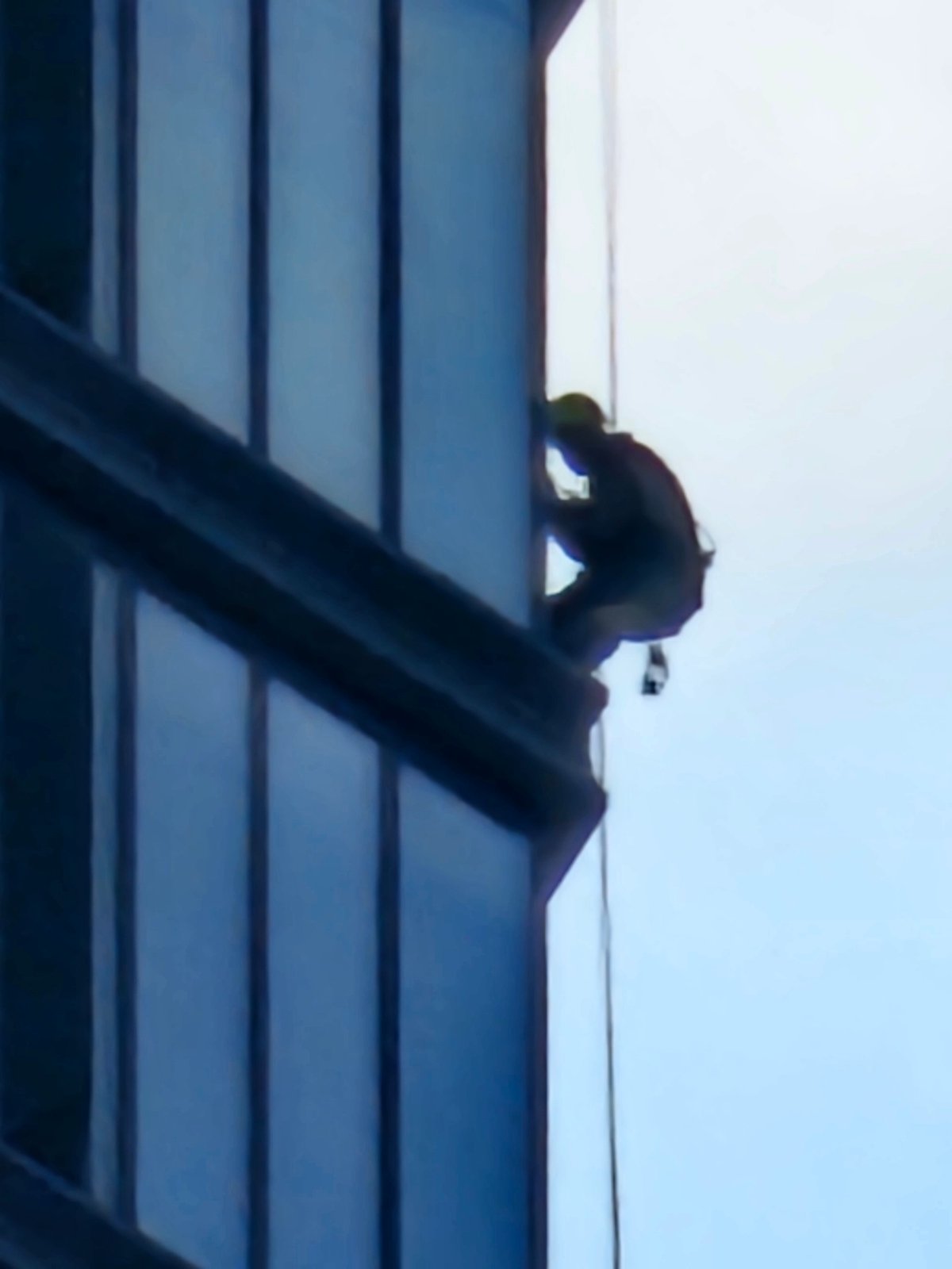 Moscow morning: high-rise window work and street traffic