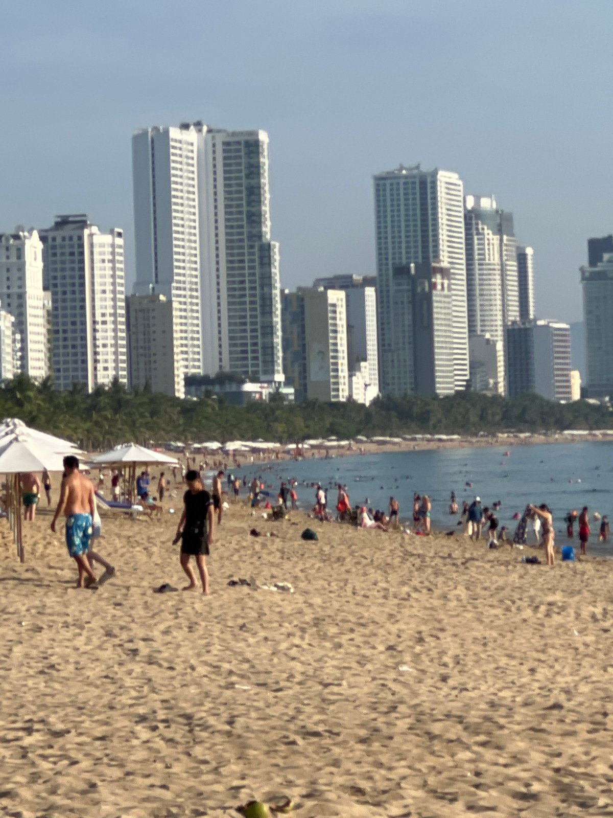 Busy evening on Nha Trang beach, locals and visitors unwinding