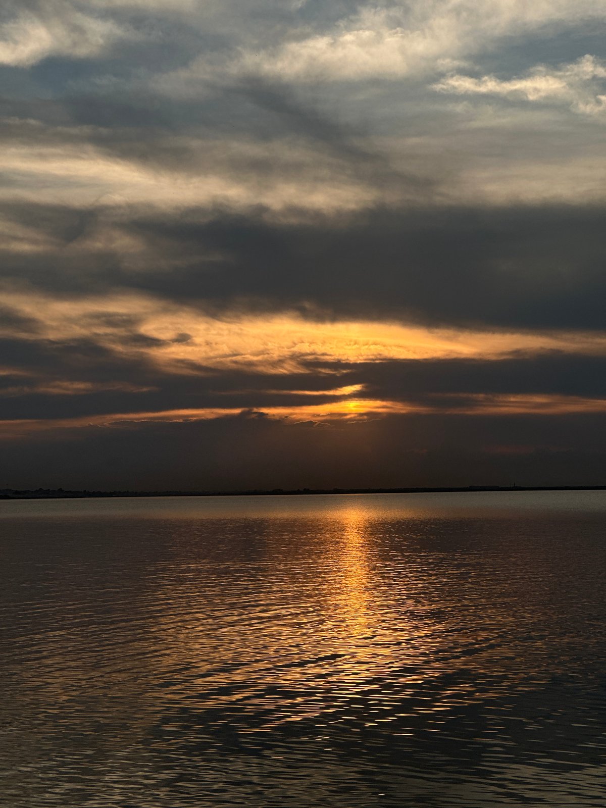 Stormy sunset over a Kokshetau lake, mid-July dusk