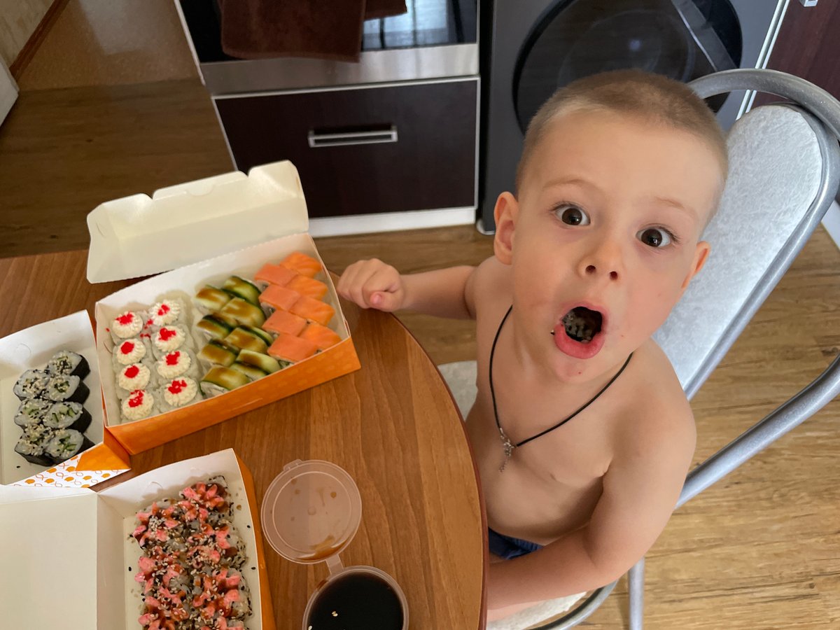 Boy eats sushi, urban landscape filmed minutes apart