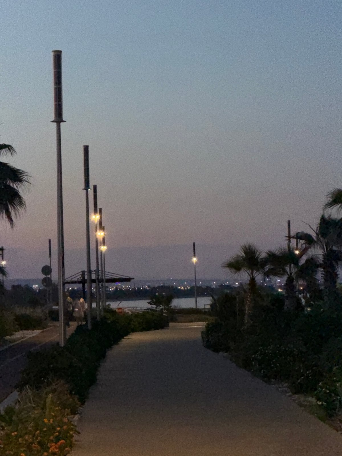 Witness documents twilight coastal promenade scene in Meneou, Cyprus