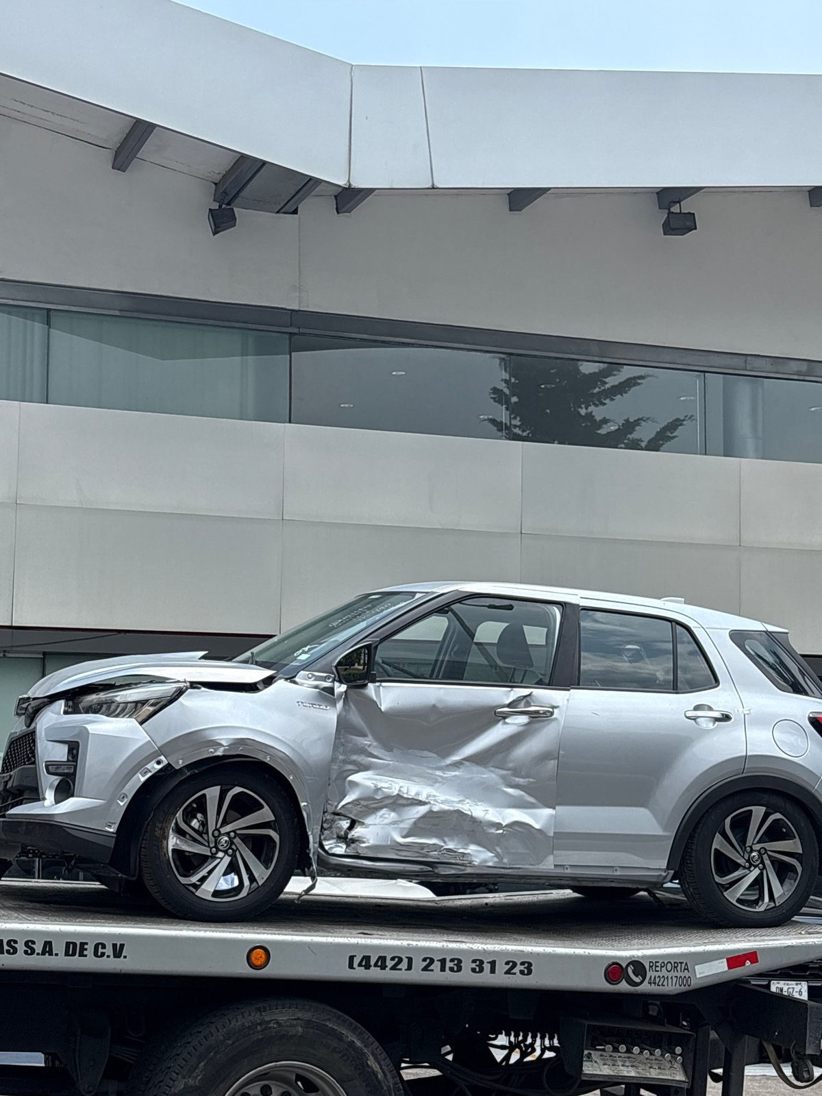 Damaged car towed from dealership area in Mexico