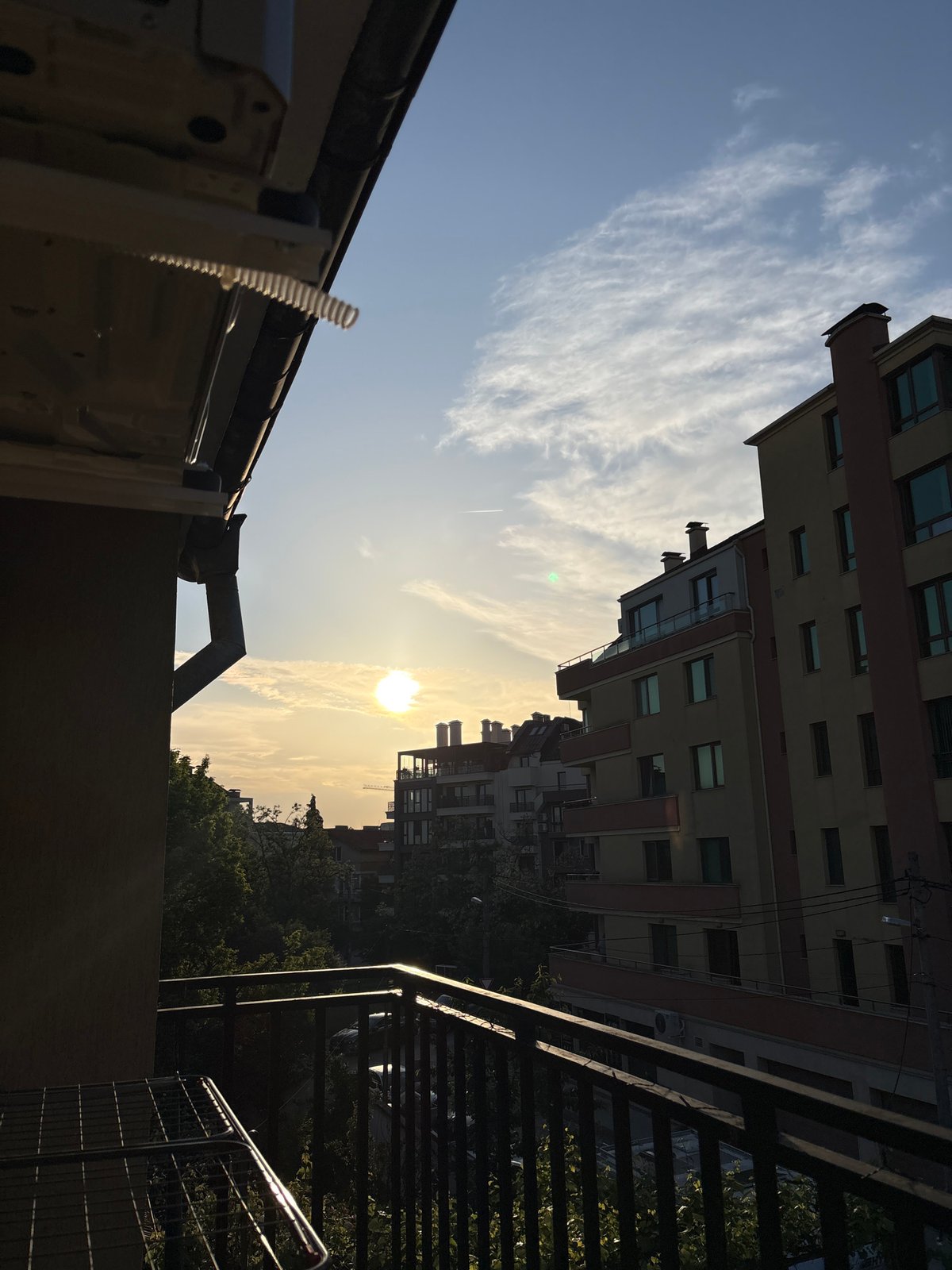 Dawn sun through hazy clouds captured from Sofia rooftop