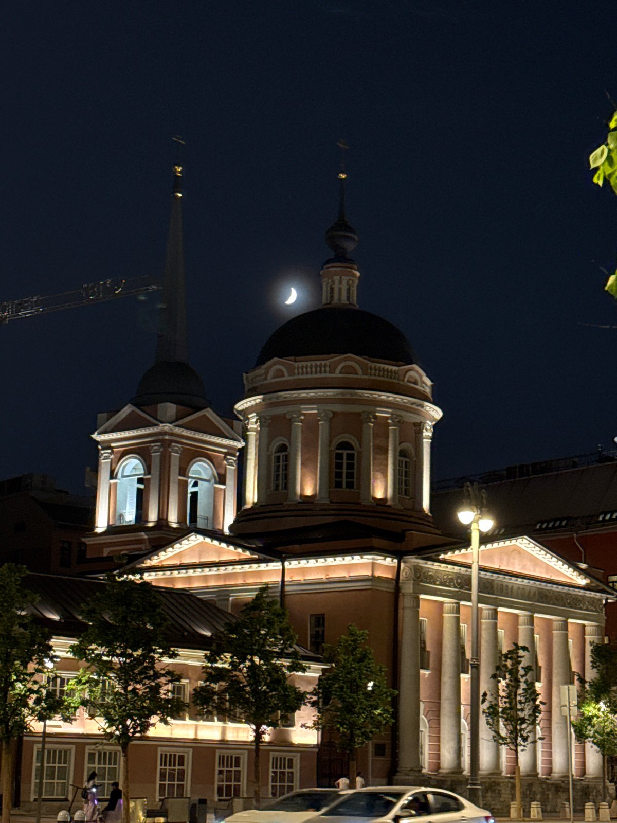 Church with black dome reflected in Moscow waters at night