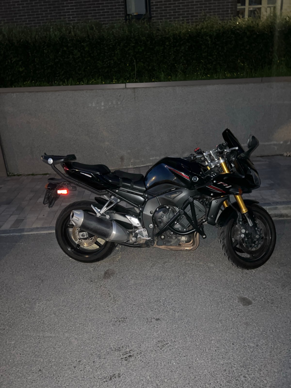 Evening street documentation captures motorcycle, buildings in Russian city
