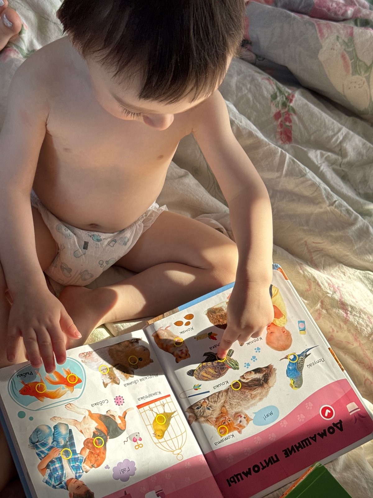 Child plays outdoors amid melting snow in Izhevsk