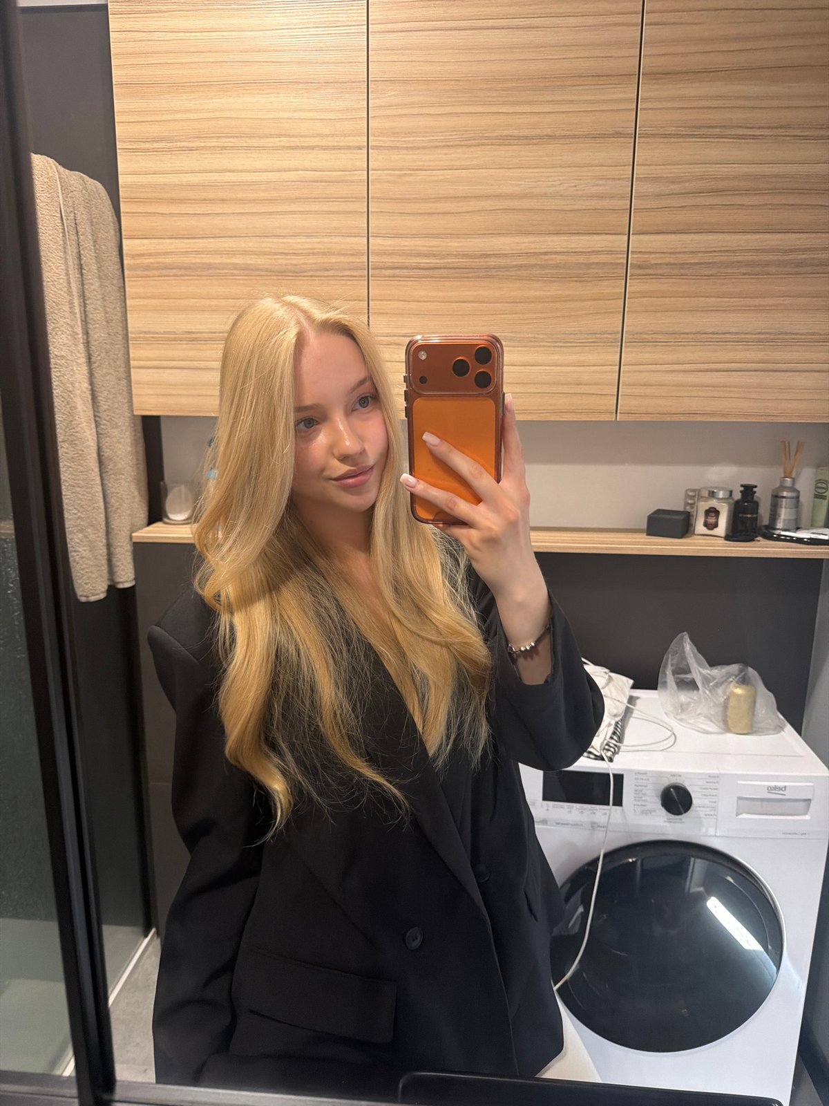 Woman Takes Multiple Bathroom Selfies with Orange Phone