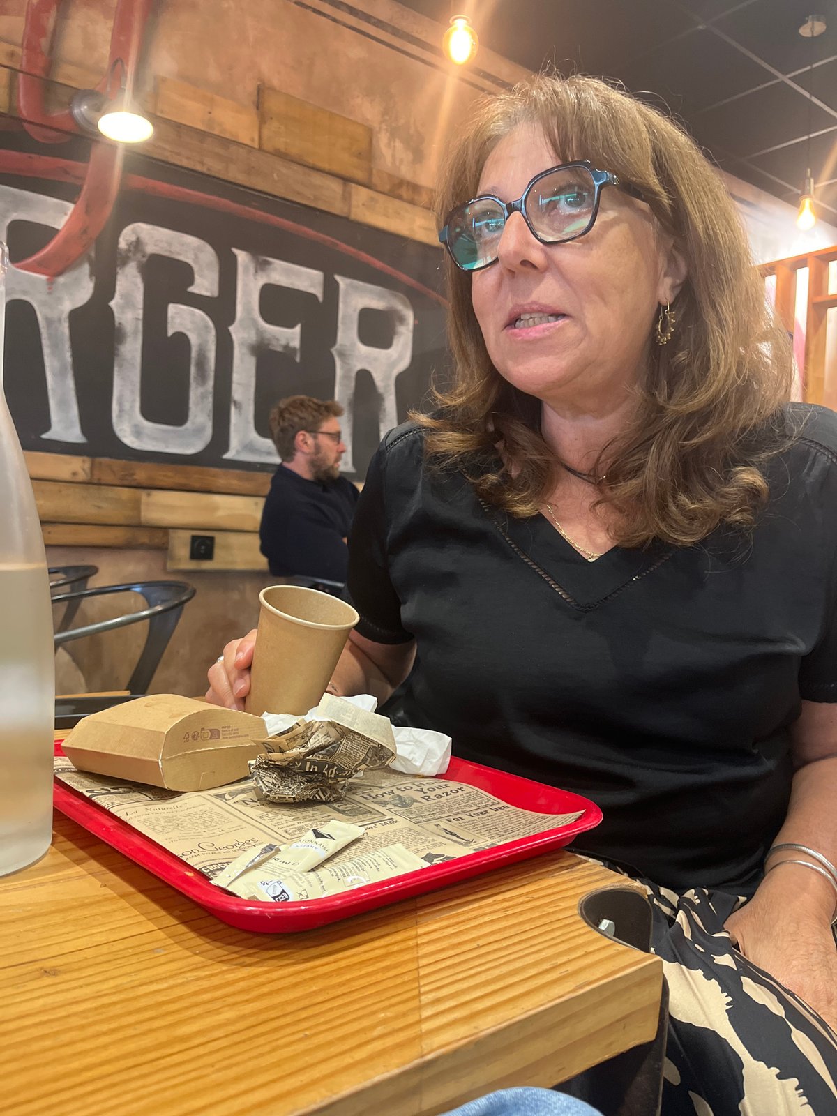 Woman dines at restaurant in Saint-Just-Saint-Rambert, France