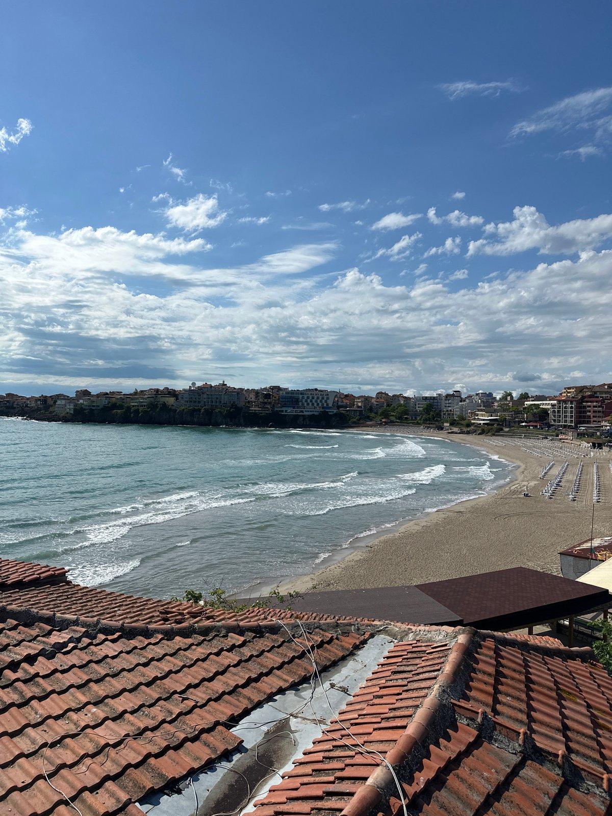Beach scene with clear skies and waves observed