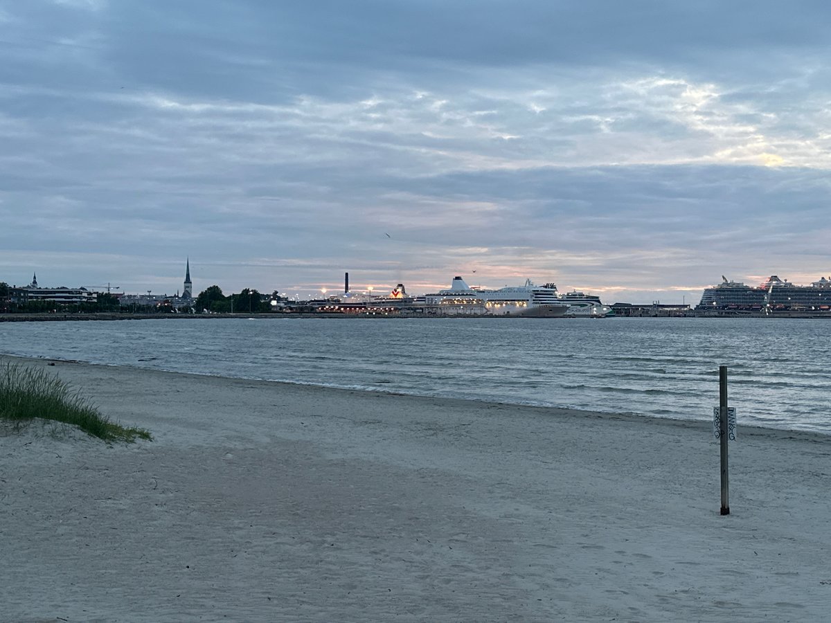 Tallinn's Baltic waterfront at dusk, cruise ships in the bay