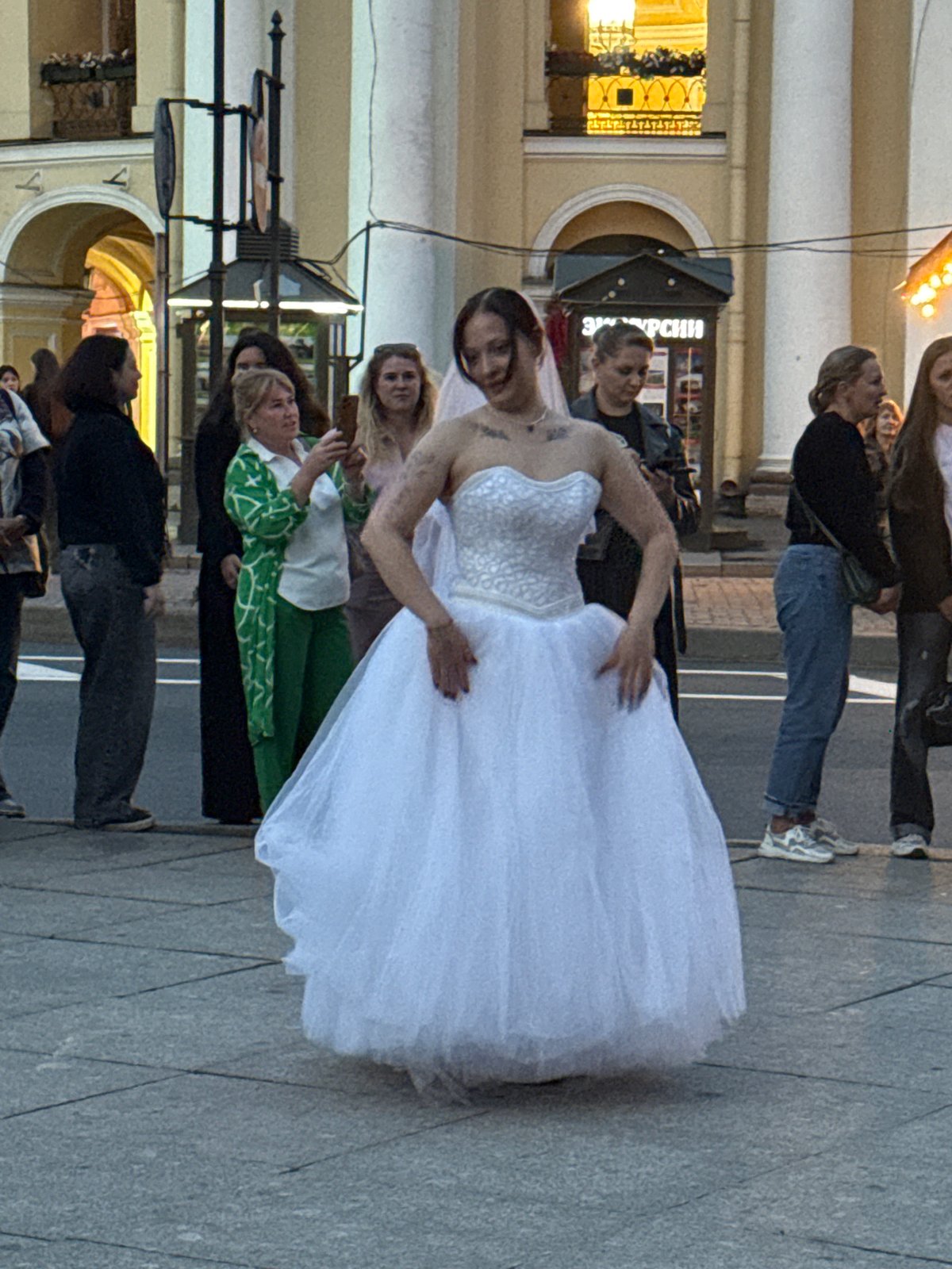 Street band and dancing brides on a Saint Petersburg plaza
