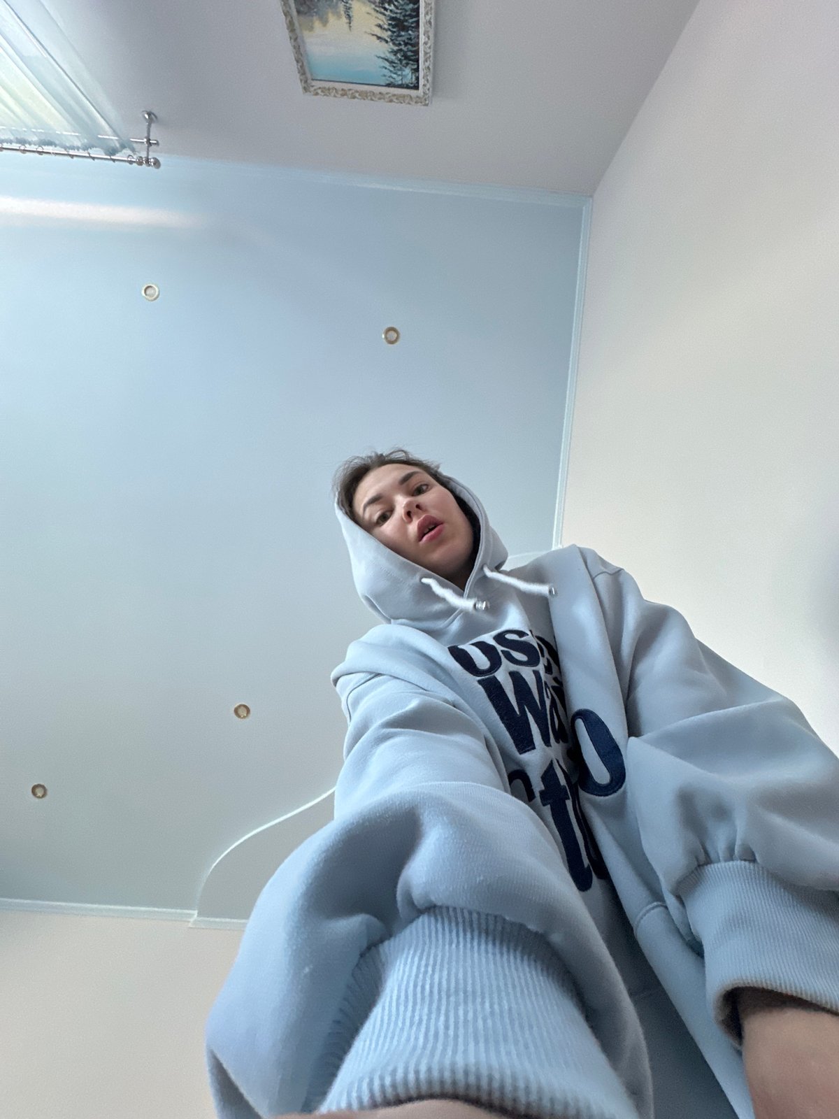 Person in blue hoodie observed indoors in Ilyinsky, Russia