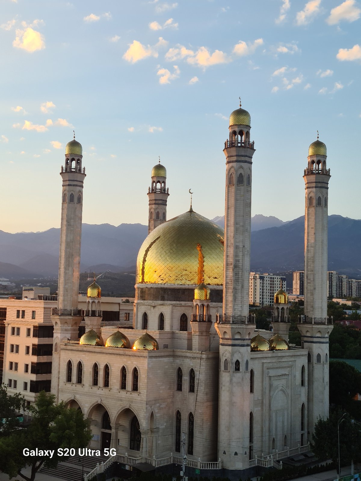 Almaty at sunset and moonrise, landmarks and skyline