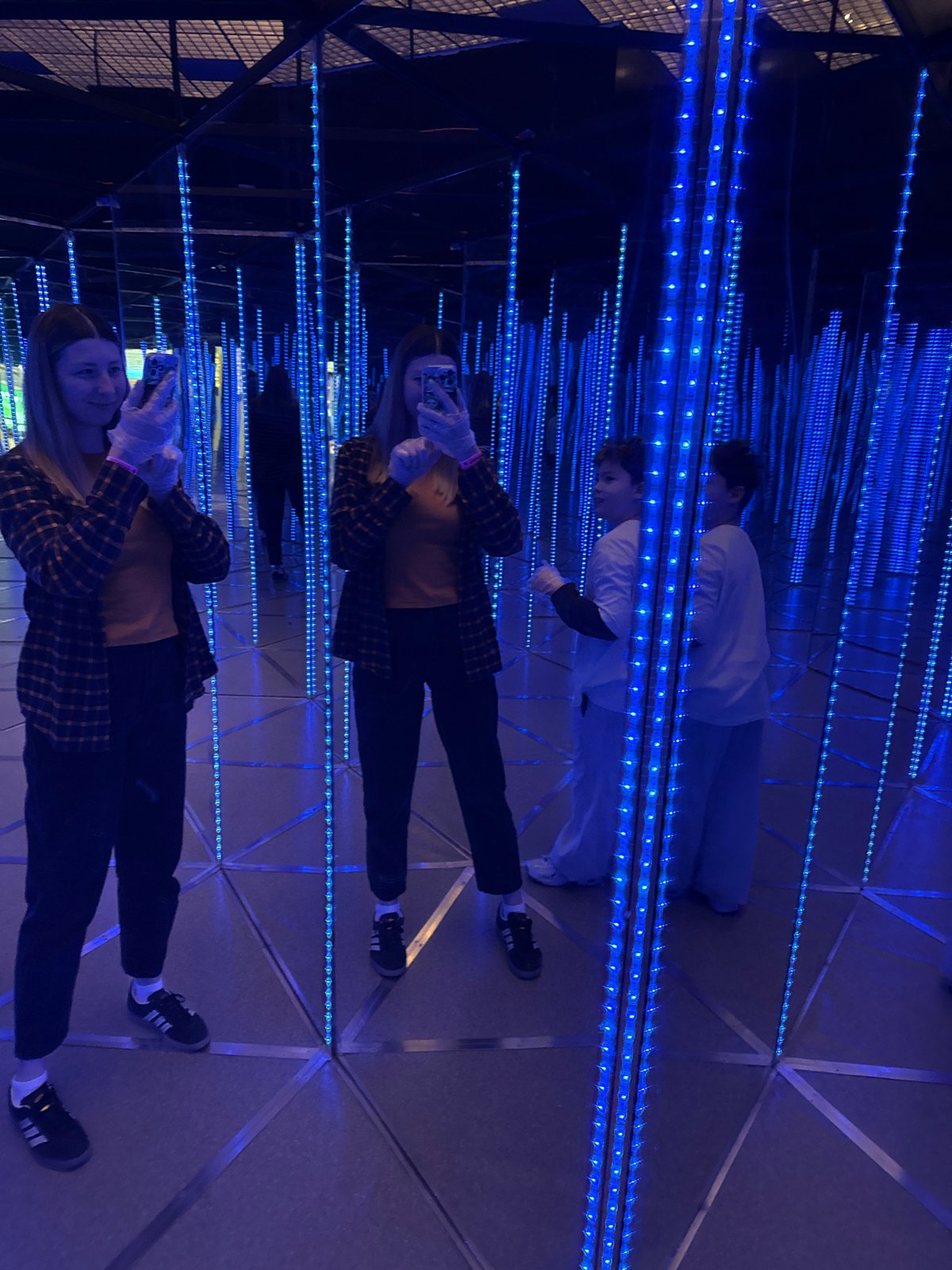 Visitors explore blue LED infinity mirror maze at Moscow museum