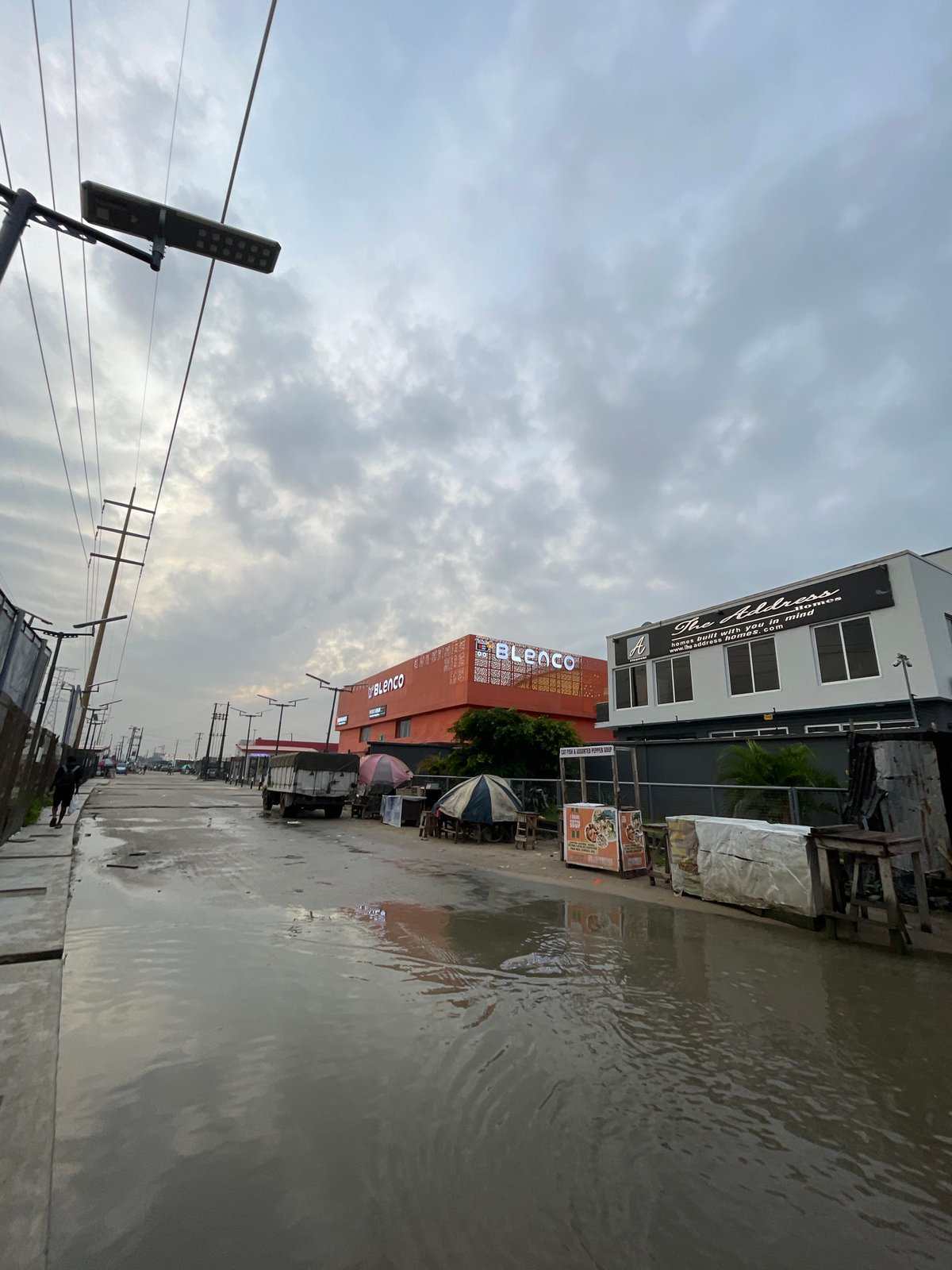 Wet morning streets and daily life in Igboefon, Lagos