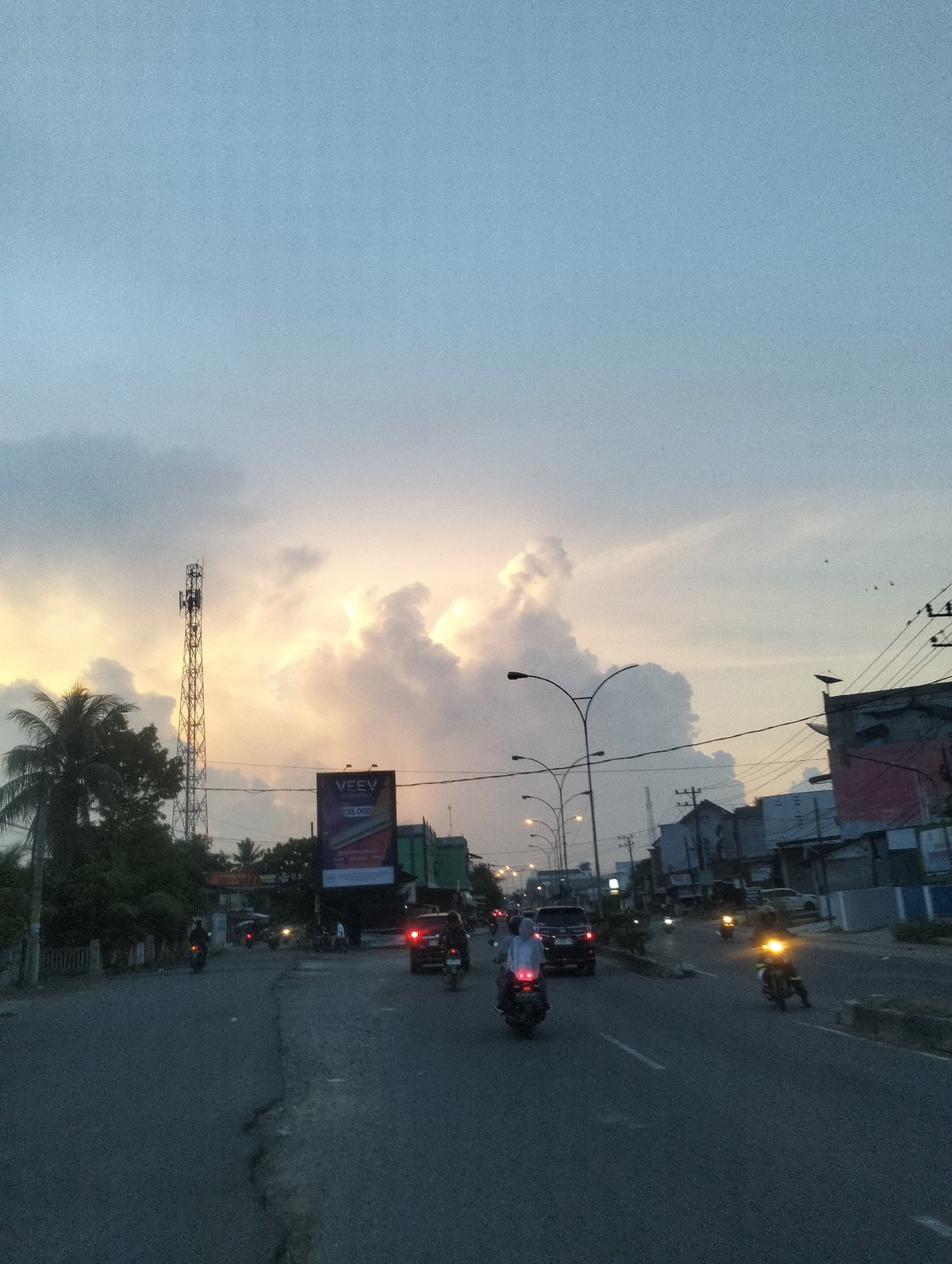 Evening street life observed in Lhokseumawe during sunset