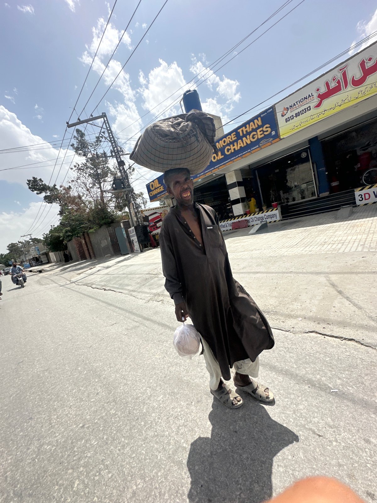 Man with traditional basket observed on Quetta sidewalk