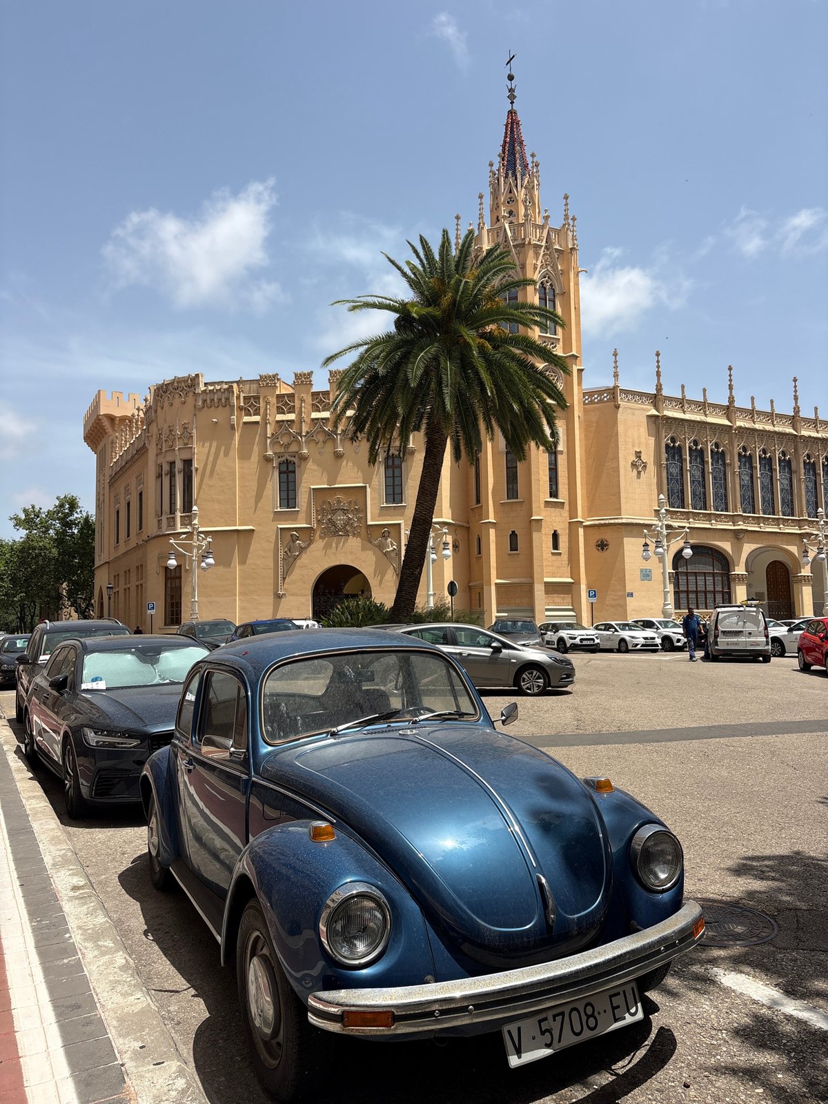 Blue Beetle parked outside Valencia's neo-Gothic landmark
