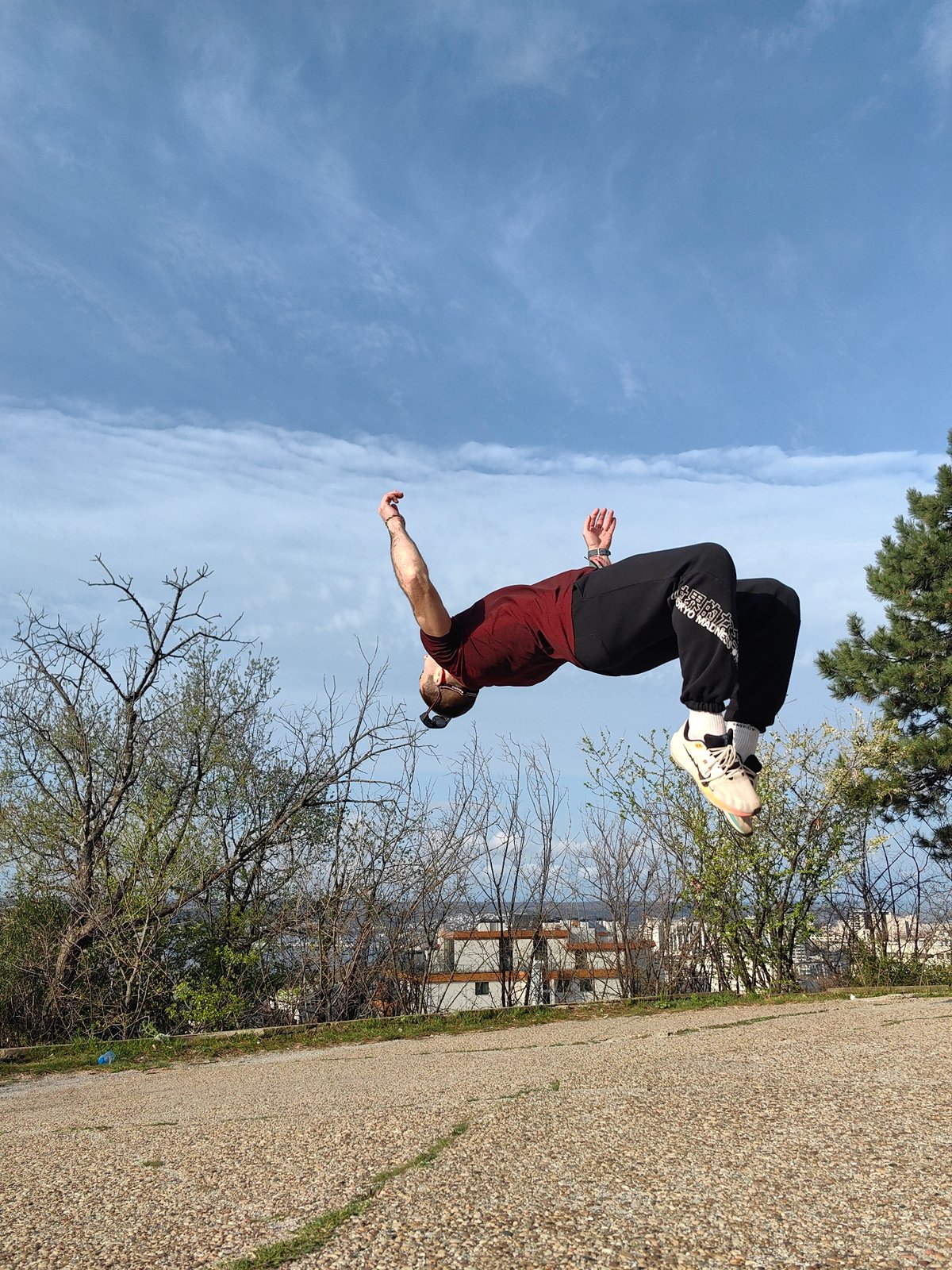 Person performs backflip outdoors in early morning Varna