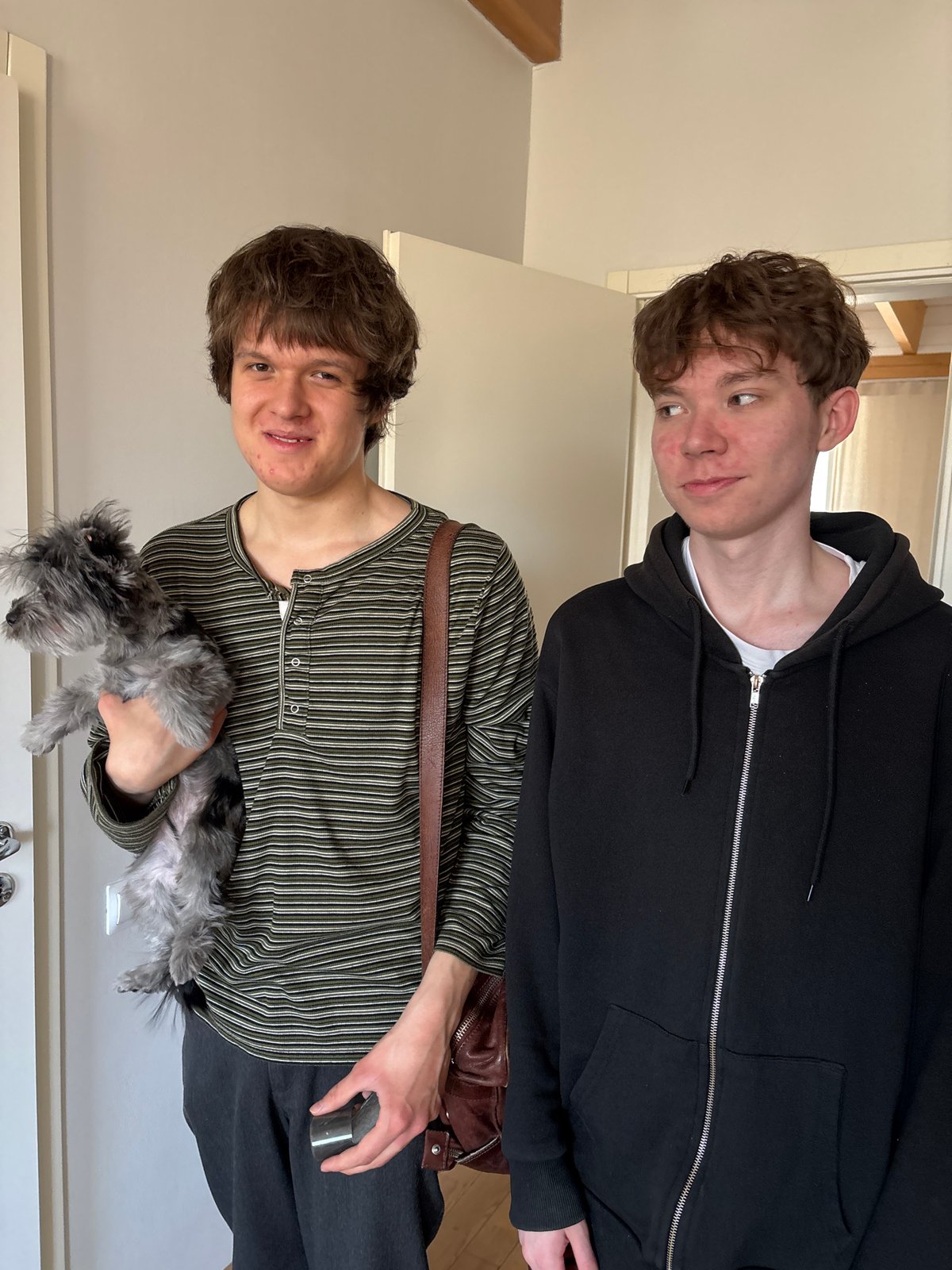Two youths and dog captured in home interior, Chaikovsky