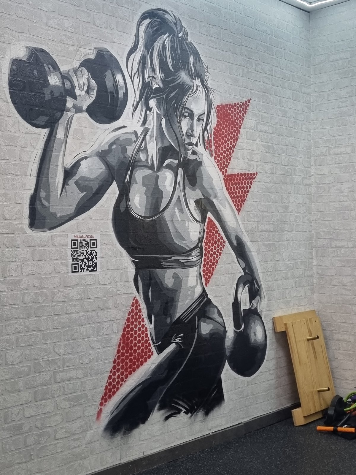 Floor artwork of weightlifting woman documented in Sochi