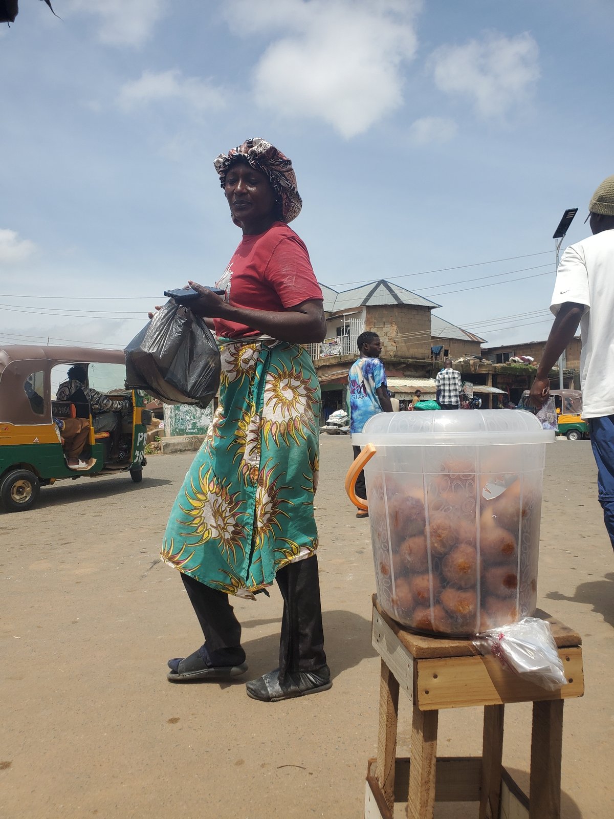 Morning street life in Gwong, Nigeria — vendors, motos, and foot traffic