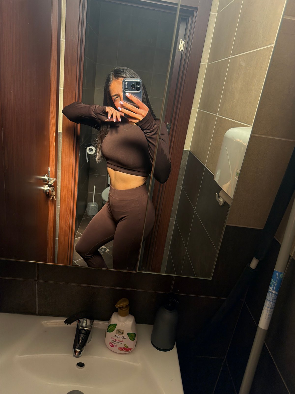 Person takes bathroom mirror selfies in Gabrovo, Bulgaria