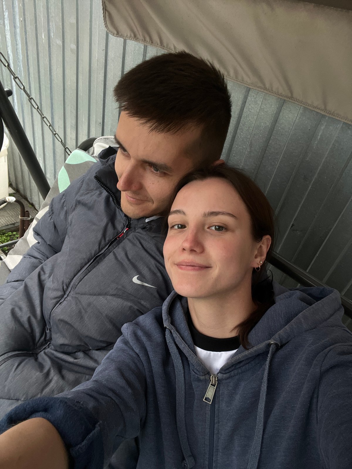 Couple documents leisurely afternoon with cats in Novocheremshansk