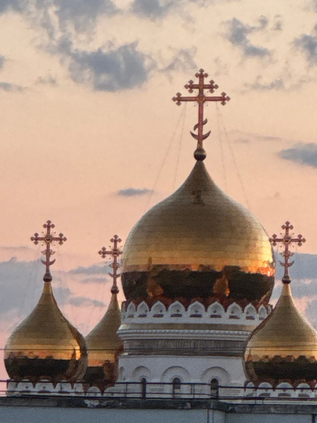 Urban sunset captured across cityscape with churches and flowers