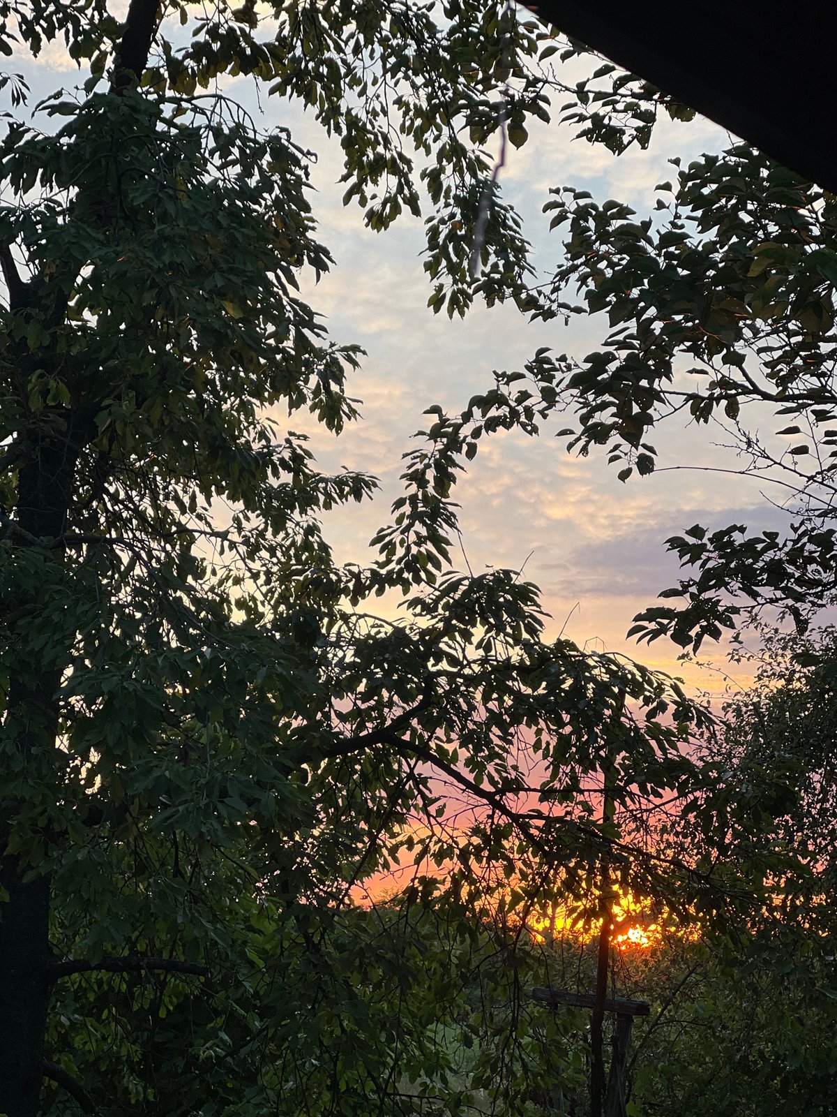Sunset to dusk across a quiet rural landscape