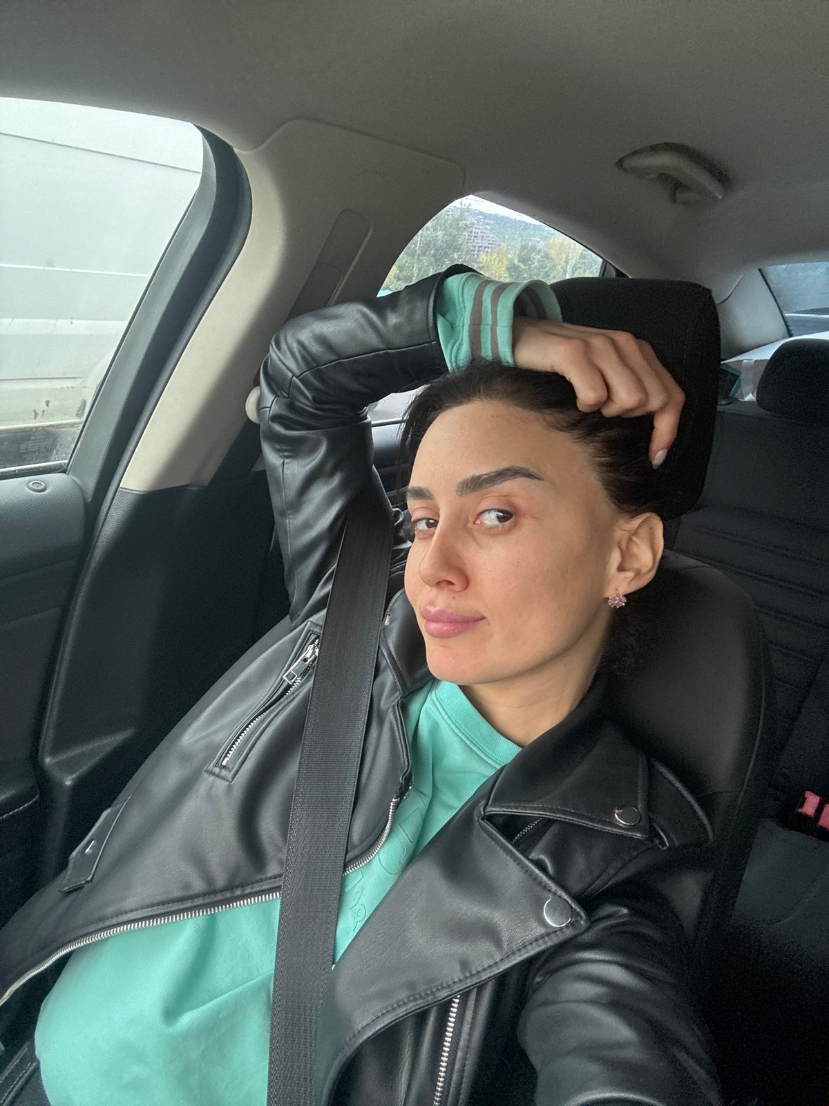 Woman photographed during car journey through Tbilisi traffic