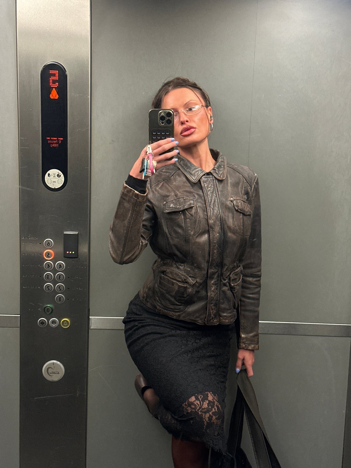 Woman takes elevator selfie in London