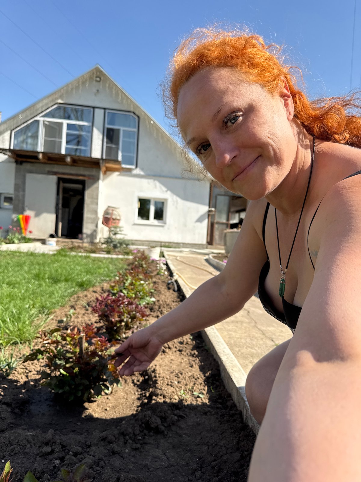 Woman gardens, snacks with dog in Chaikovsky, Russia
