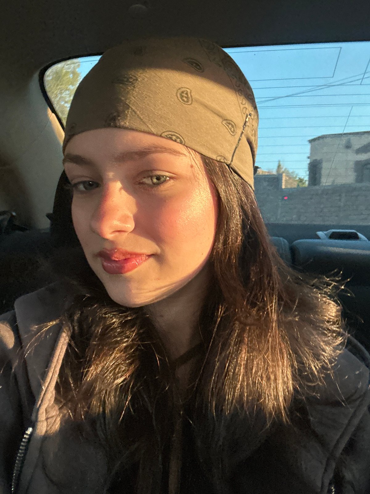 Young woman documents afternoon car journey through Yerevan selfies